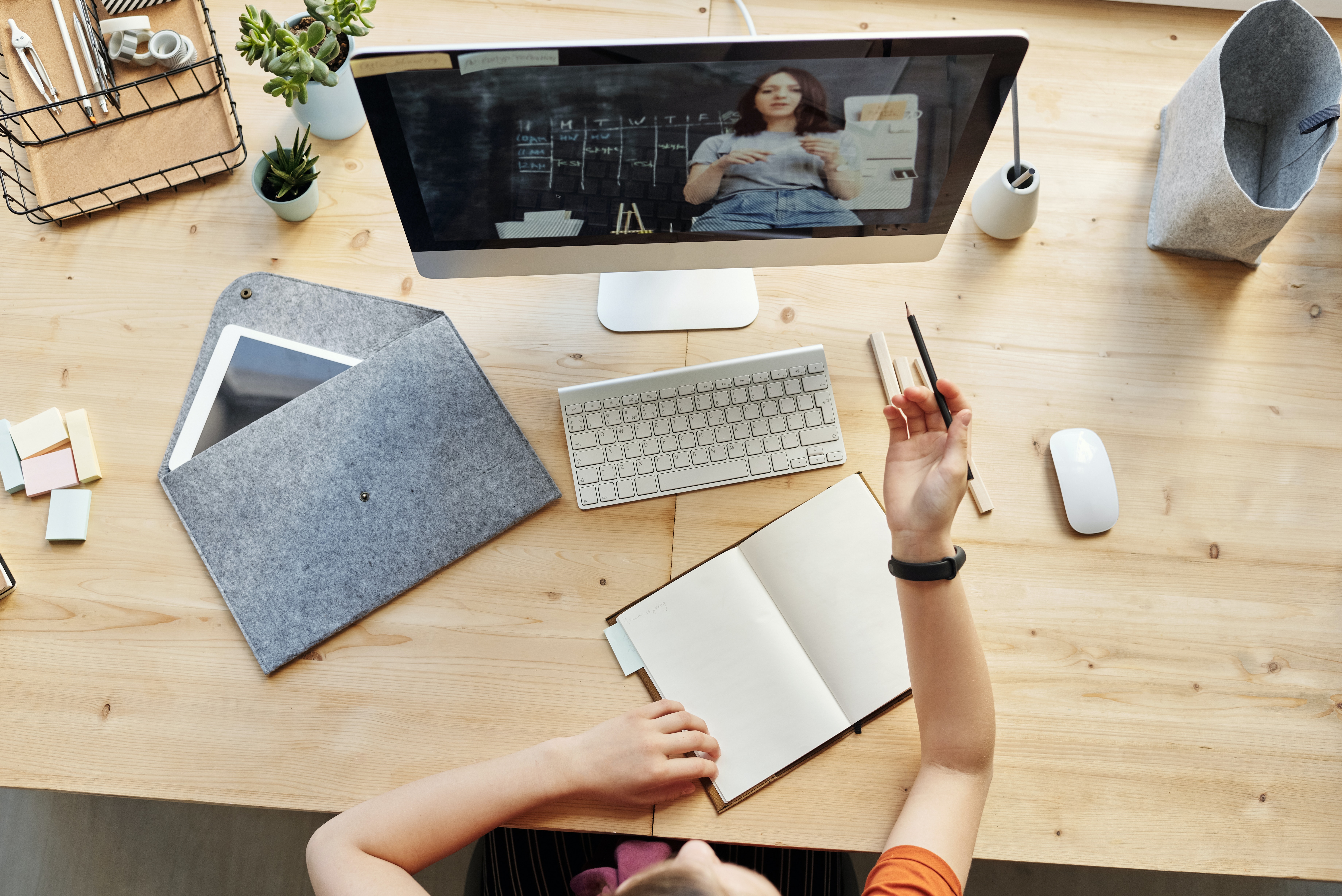 top view photo of girl watching through imac 4144294